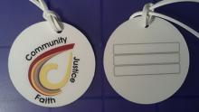 White round bag tags with multi-color CWACM logo
