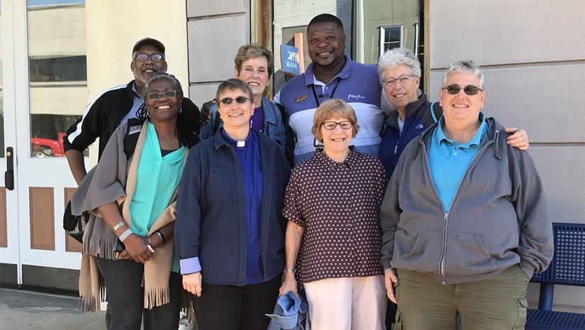 Eight participants in Justice Summit 2018 Birmingham stand outside a house