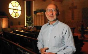 Greg Dell standing in a church sanctuary.